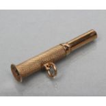 A 9CT GOLD CIGAR PIERCER, Birmingham 1949, with engine turned panel and hanging loop, 1 3/4" long,