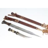 FOUR AFRICAN DAGGERS, comprising two similar (possibly Congolese) knives with decorative leather