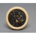 A JAPANESE KAGAMIBUTA NETSUKE, Meiji period, the shibuchi(?) disc cast with a seated Ashinaga,