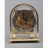 A KIENINGER MANTEL CLOCK, the exposed quarter chiming gong striking movement with eleven jewels