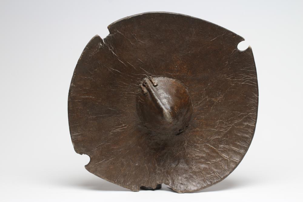 A SUDANESE BEJAN SHIELD, late 19th/early 20th century, of circular form with central boss and