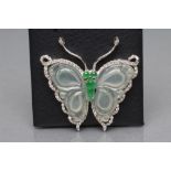 A BUTTERFLY PENDANT, with carved chalcedony shaped wings, cabochon emerald set body and head