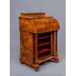 AN EARLY VICTORIAN FIGURED WALNUT DAVENPORT, with stringing and marquetry paterae, the waisted