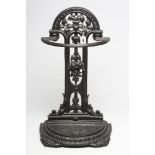 A VICTORIAN CAST IRON STICK STAND, the arched and waisted back pierced and moulded with flowers,
