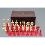 AN ENGLISH IVORY CHESS SET, mid 19th century, stained red and natural with turned sectional