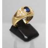A SIGNET RING centred by a collet set cushion cut sapphire within triangular shoulder panels each