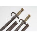 TWO FRENCH YATAGHAN SWORD BAYONETS for the Chassepot, both dated 1872, with ribbed brass grip and