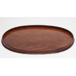 A LARGE GEORGIAN MAHOGANY TRAY of oval form with plain solid gallery, 28 14" x 21 1/2" (Est. plus