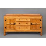 A ROBERT THOMPSON ADZED OAK SIDEBOARD, the moulded edged top with ledge back, three central
