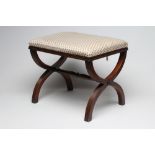 A REGENCY STYLE MAHOGANY X FRAMED STOOL, 20th century, the oblong pegged upholstered seat in an
