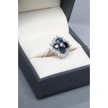 A SAPPHIRE AND DIAMOND CLUSTER RING, the four facet cut sapphires point set to a brilliant cut