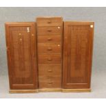 A TOKEN HAND MADE MAHOGANY TRIPLE WARDROBE of inverted breakfront form, the raised centre section