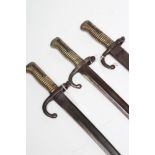 A FRENCH YATAGHAN SWORD BAYONET for the Chassepot, dated 1874, with ribbed brass grip, button