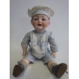 A Franz Schmidt & Co. bisque socket head doll, with blue glass sleeping eyes, open mouth and