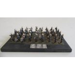 32mm Royal Marines marching band affixed to wooden base, F (Est. plus 21% premium inc. VAT)