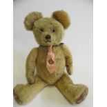 A pre-war "George" growler teddy, with clear glass eyes, sewn nose and mouth, faux leather pads, and