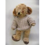 A Merry Thought Cheeky bear, 1950s, with amber eyes, bells in ears, felt pads and label to foot,