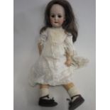 A Heubach Koppelsdorf bisque socket head doll, with brown glass sleeping eyes, open mouth and teeth,
