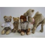 Four stuffed animals comprising a large camel, with one felt eyelid, wired legs and woven pads,