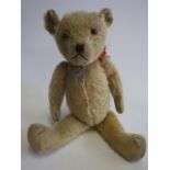 A pre-war Merry Thought teddy, with glass amber eyes, sewn nose and mouth, cloth pads, Merry Thought