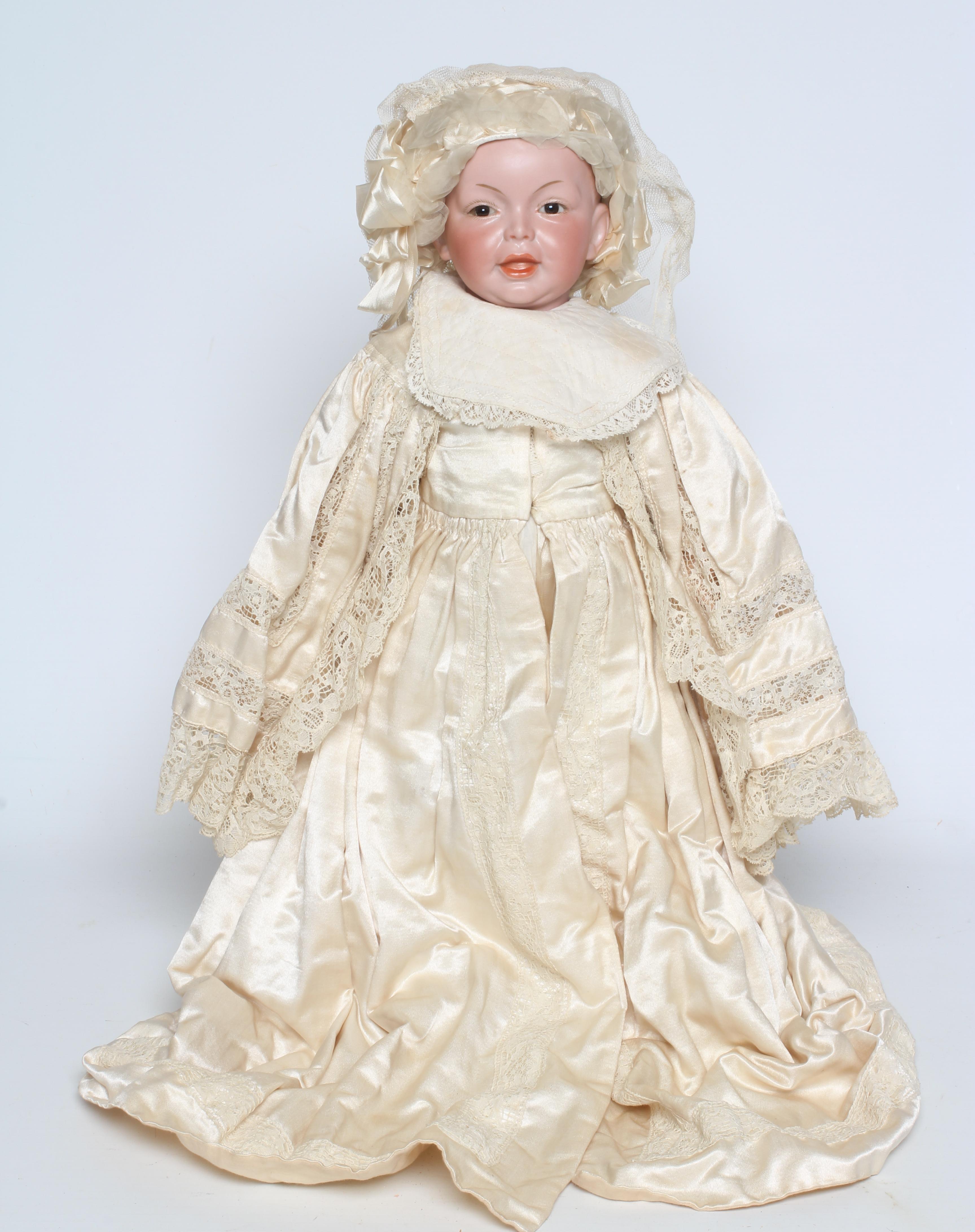 An SFBJ bisque socket head character doll, with fixed brown glass eyes, jointed wood and composition