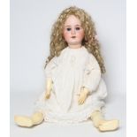 A large bisque socket head doll, with blue paperweight sleeping eyes, open mouth and teeth,