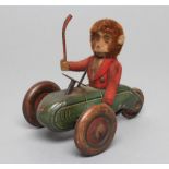 Early Schuco clockwork monkey in tricycle with hockey stick, F, and a clockwork plush covered