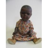 A Heubach Koppelsdorf mulatto character doll, with bisque socket head, brown glass sleeping eyes,