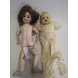 An SFBJ bisque socket head doll, with brown glass sleeping eyes, brown wig, open mouth and teeth,