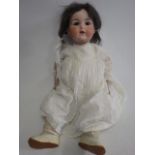 An Armand Marseille bisque socket head doll, with grey glass sleeping eyes, open mouth, teeth and