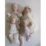 Four late 20th century bisque head dolls, comprising two Boots Tyner "Sugar Lump" babies, with