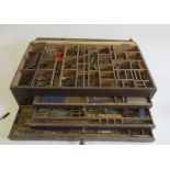 A wooden box with tray and three drawers containing mainly blue and silver Meccano parts, most items