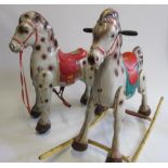 Two children's pressed steel rocking horses, one with spring action and wheels, the other on steel