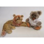 A Steiff grey long haired bear, with amber eyes, open mouth, felt pads and button to ear, 9" tall,