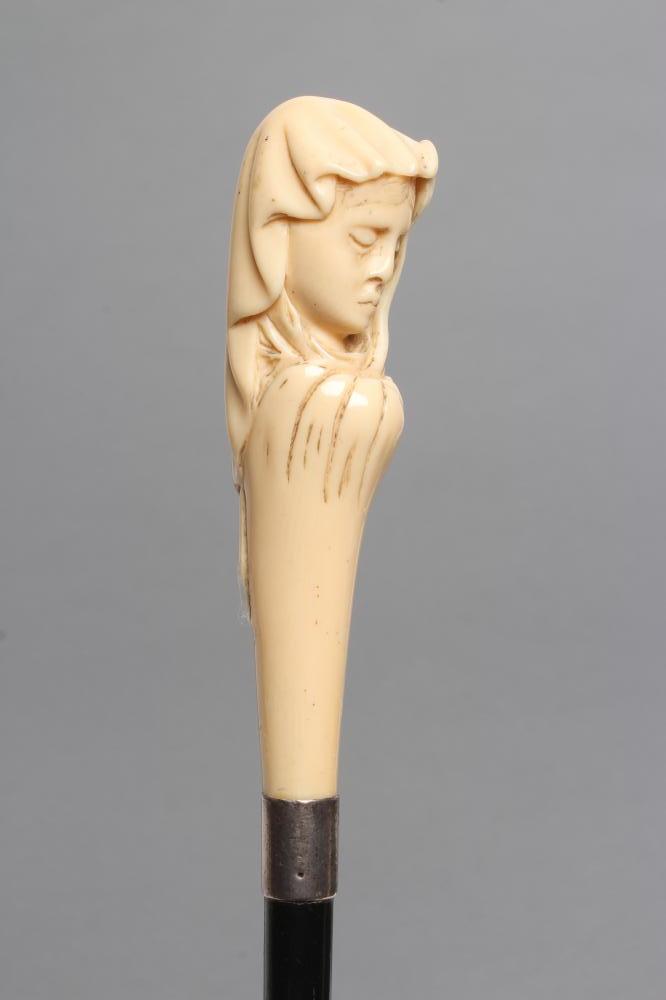 A LADY'S VICTORIAN WALKING CANE, the ivory grip carved as the head of a young maiden wearing a veil,