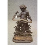 A VICTORIAN CAST IRON STICK STAND modelled as a Putto (possibly the young Hercules) standing amongst