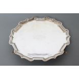 A STERLING SILVER SALVER, maker Hamilton & Co., India, c.1939, of shaped circular form with pie-