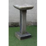 A STONE AND COMPOSITE BIRD BATH of square section, the moulded top with shallow depression, on