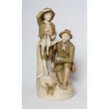 A ROYAL DUX FIGURE GROUP, early 20th century, the hunter kneeling and holding a rifle, his young