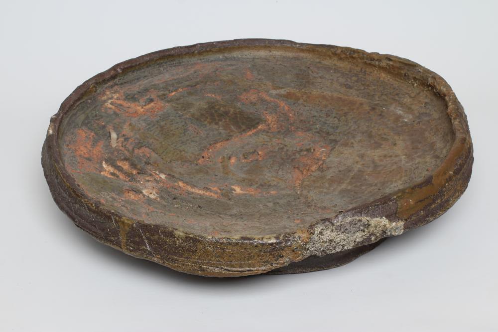 CHARLES BOUND (b.1939) - a large anagama fired stoneware circular plaque, approximately 24" diameter