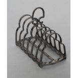 A SILVER SEVEN BAR TOASTRACK, maker's mark GH, Sheffield 1917, of ogee form with central spade