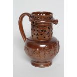 A VICTORIAN BROWN SALT GLAZED STONEWARE PUZZLE JUG of typical form with three spouts, the sprigged