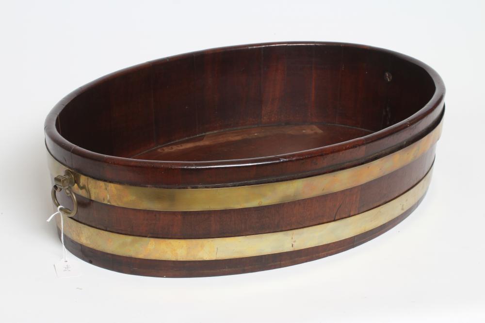 A GEORGIAN MAHOGANY CELLARETTE/JARDINIERE, mid/late 18th century, of oval staved form with brass