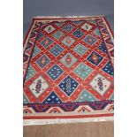 A LARGE PERSIAN STYLE FLAT WOVEN KILIM, modern, the bright red field with repeating large gul