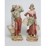 A PAIR OF ROYAL DUX FIGURES, early 20th century, modelled as a young peasant couple wearing