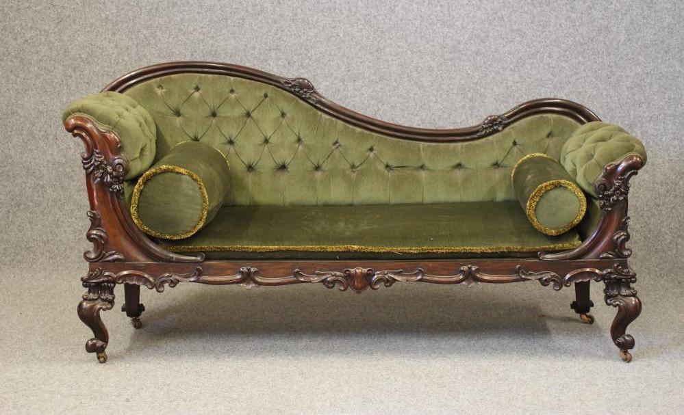 A WILLIAM IV ROSEWOOD SOFA, the show wood frame carved with flowers and scrollwork, button