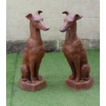 A PAIR OF CAST METAL GREYHOUNDS, modelled seated and raised on a hexagonal base, 36" high (Est. plus