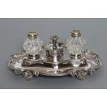 A LATE VICTORIAN EPNS DESK STAND, maker Elkington, the quatrefoil base with scroll rim centred by