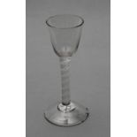 A CORDIAL GLASS, mid 18th century, the round funnel bowl on a plain cylindrical double twist stem
