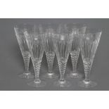 A SET OF SIX GLASS GOBLETS, c.1920's, the conical bowls with slice and printe cut panels on a printe